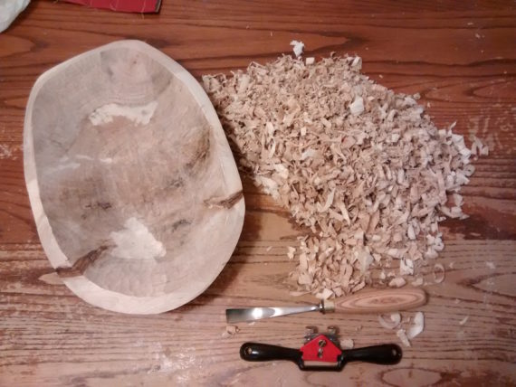 Smoothing out the insides of the bowl with a gouge